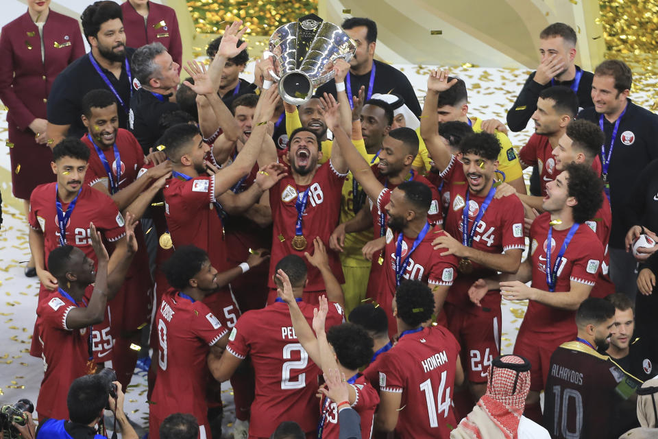 Qatar's team lift the trophy after winning the AFC Asian Cup final match between Qatar and Jordan at the Lusail Stadium in Lusail, Qatar, Saturday, Feb. 10, 2024. (AP Photo/Hussein Sayed)