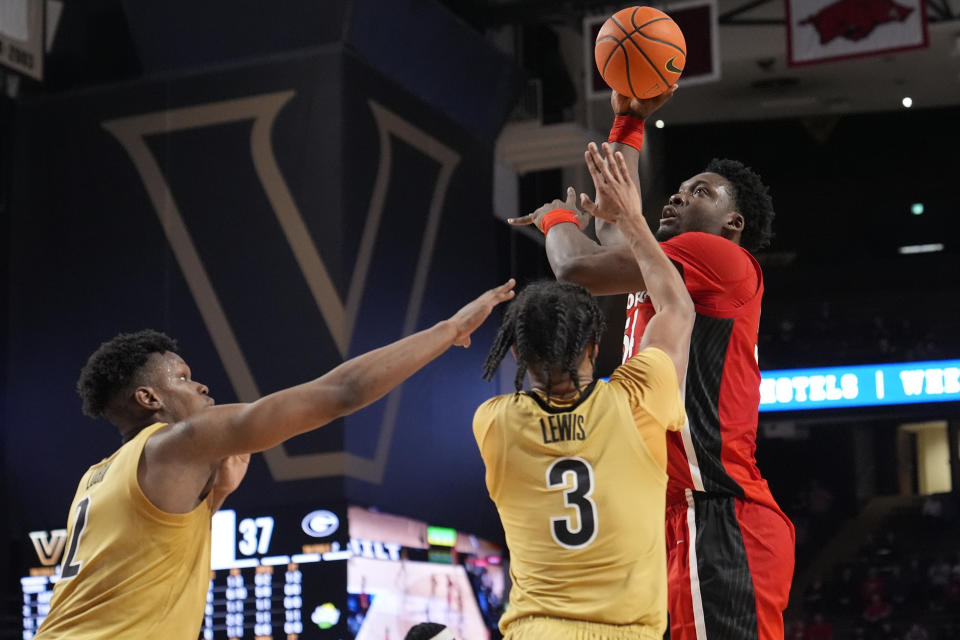 Georgia center Russel Tchewa, right, shoots the ball over Vanderbilt forward Ven-Allen Lubin, left, and guard Paul Lewis (3) during the first half of an NCAA college basketball game Wednesday, Feb. 21, 2024, in Nashville, Tenn. (AP Photo/George Walker IV)