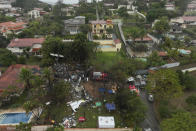 Firefighters and rescue teams work at the site in a residential area where an airplane with 61 people on board crashed in Vinhedo, Sao Paulo state, Brazil. (AP Photo/Andre Penner)