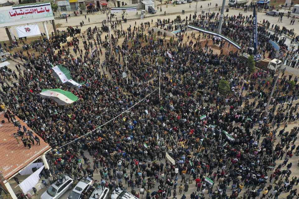 Thousands of anti-Syrian government protesters mark 10 years since the start of a popular uprising against President Bashar Assad's rule, that later turned into an insurgency and civil war, In Idlib, the last major opposition-held area of the country, in northwest Syria, Monday, March 15, 2021. (AP Photo/Ghaith Alsayed)