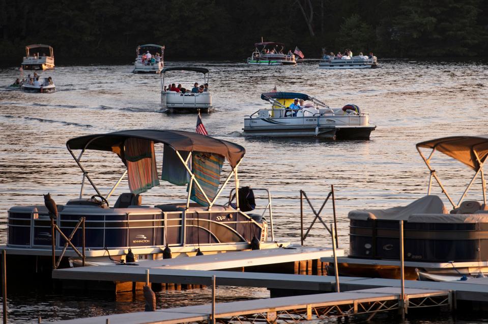 Boats get into position for the biannual July Fourth boat parade on Lake Wickaboag in 2020.