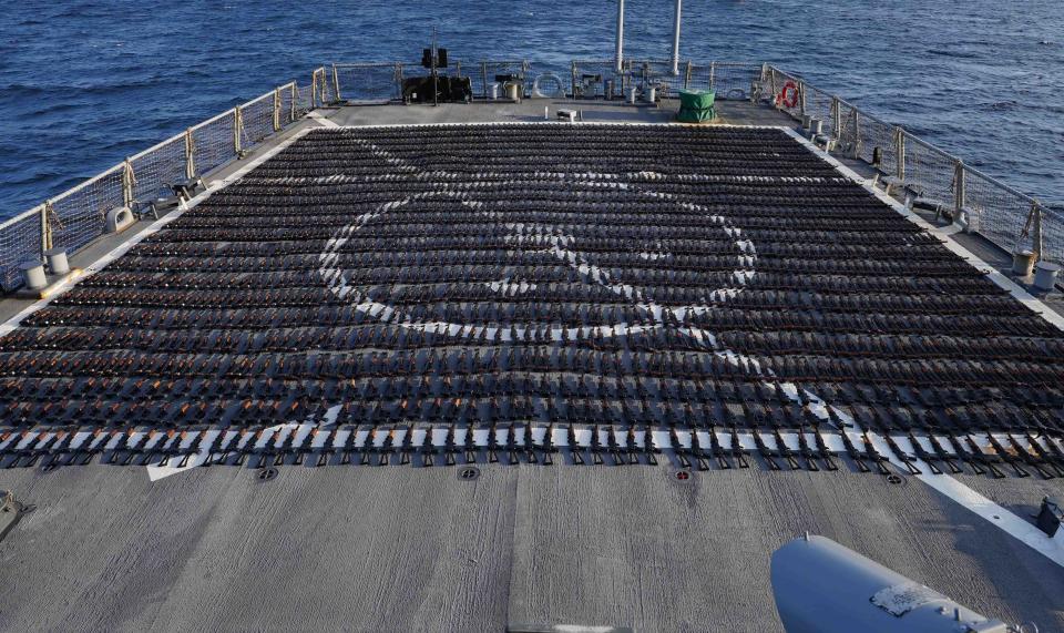 Thousands of AK-47 assault rifles sit on the flight deck of guided-missile destroyer USS The Sullivans (DDG 68) during an inventory process, Jan. 7. U.S. naval forces seized 2,116 AK-47 assault rifles from a fishing vessel transiting along a maritime route from Iran to Yemen.