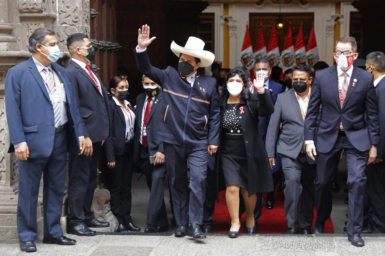 FILE - Peru's President-elect Pedro Castillo and wife Lilia Paredes wave as they leave the Foreign Ministry to go to Congress for his swearing-in ceremony on his inauguration aay in Lima, Peru, July 28, 2021. On Dec 7, 2022, Castillo dissolved the nation's Congress and called for new legislative elections as lawmakers prepared to debate a third attempt to remove him from office. (AP Photo/Guadalupe Pardo, File)