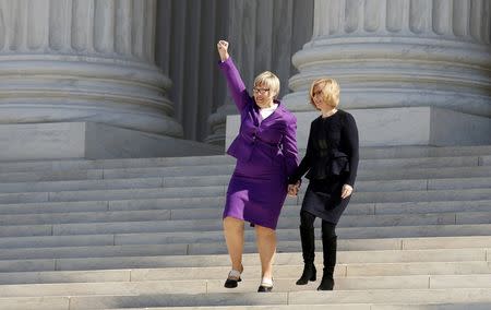 President and CEO of Whole Women's Health Amy Hagstrom Miller (L) holds up her fist as she descends the steps of the U.S. Supreme Court with President and CEO of the Center for Reproductive Rights Nancy Northup after the court took up a major abortion case focusing on whether a Texas law that imposes strict regulations on abortion doctors and clinic buildings interferes with the constitutional right of a woman to end her pregnancy in Washington March 2, 2016. REUTERS/Kevin Lamarque/File Photo
