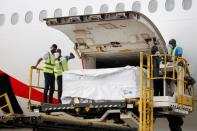 FILE PHOTO: Workers offload boxes of AstraZeneca/Oxford vaccines as the country receives its first batch of coronavirus disease (COVID-19) vaccines under COVAX scheme, in Accra