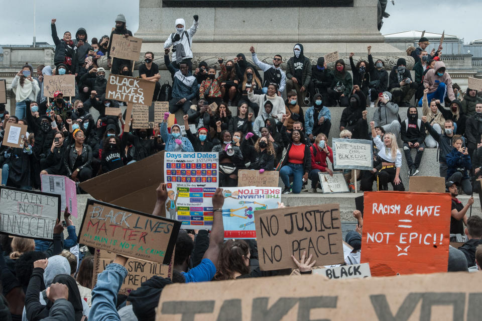 LONDON, ENGLAND - JUNE 7: Protesters hold placards and hold their fists in the air on Nelson's Column as thousands join a second day of Black Lives Matter protest on June 7, 2020 in London, United Kingdom. The death of an African-American man, George Floyd, while in the custody of Minneapolis police has sparked protests across the United States, as well as demonstrations of solidarity in many countries around the world. (Photo by Guy Smallman/Getty Images)