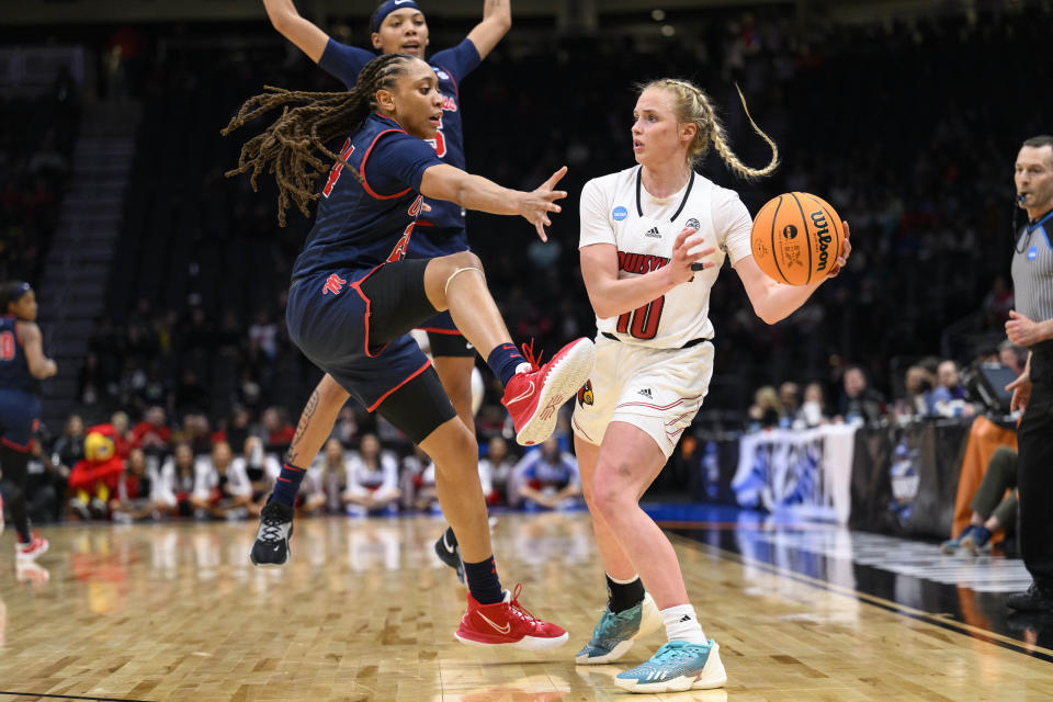 Mississippi forward Madison Scott, left, attempts to block a pass by Louisville guard Hailey Van Lith during the second half of a Sweet 16 college basketball game of the women's NCAA Tournament in Seattle, Friday, March 24, 2023. (AP Photo/Caean Couto)