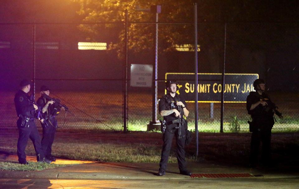 Summit County sheriff's deputies block the intersection of Bellows and Crosier streets Tuesday night after protests outside Summit County Jail in Akron.