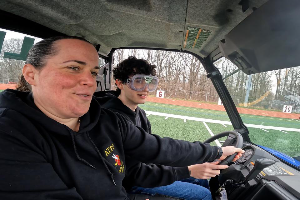 Adam Aljendi, 17, of Matawan wears impairment googles and attempts to drive in a straight line and around a series of cones with Aberdeen Twp. Police Officer Jessica Marr during Road Safety Day at Matawan Regional High School in Aberdeen Twp., NJ Thursday, April 11, 2024.