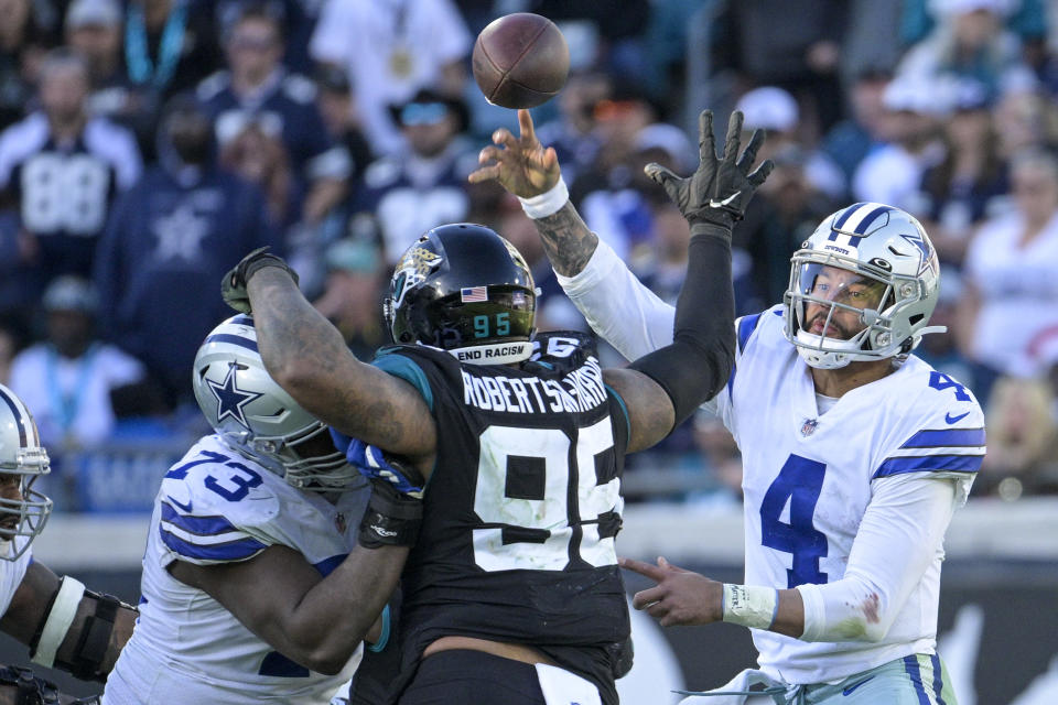 Dallas Cowboys quarterback Dak Prescott (4) throws an interception pass during overtime in an NFL football game against Jacksonville Jaguars, Sunday, Dec. 18, 2022, in Jacksonville, Fla. (AP Photo/Phelan M. Ebenhack)