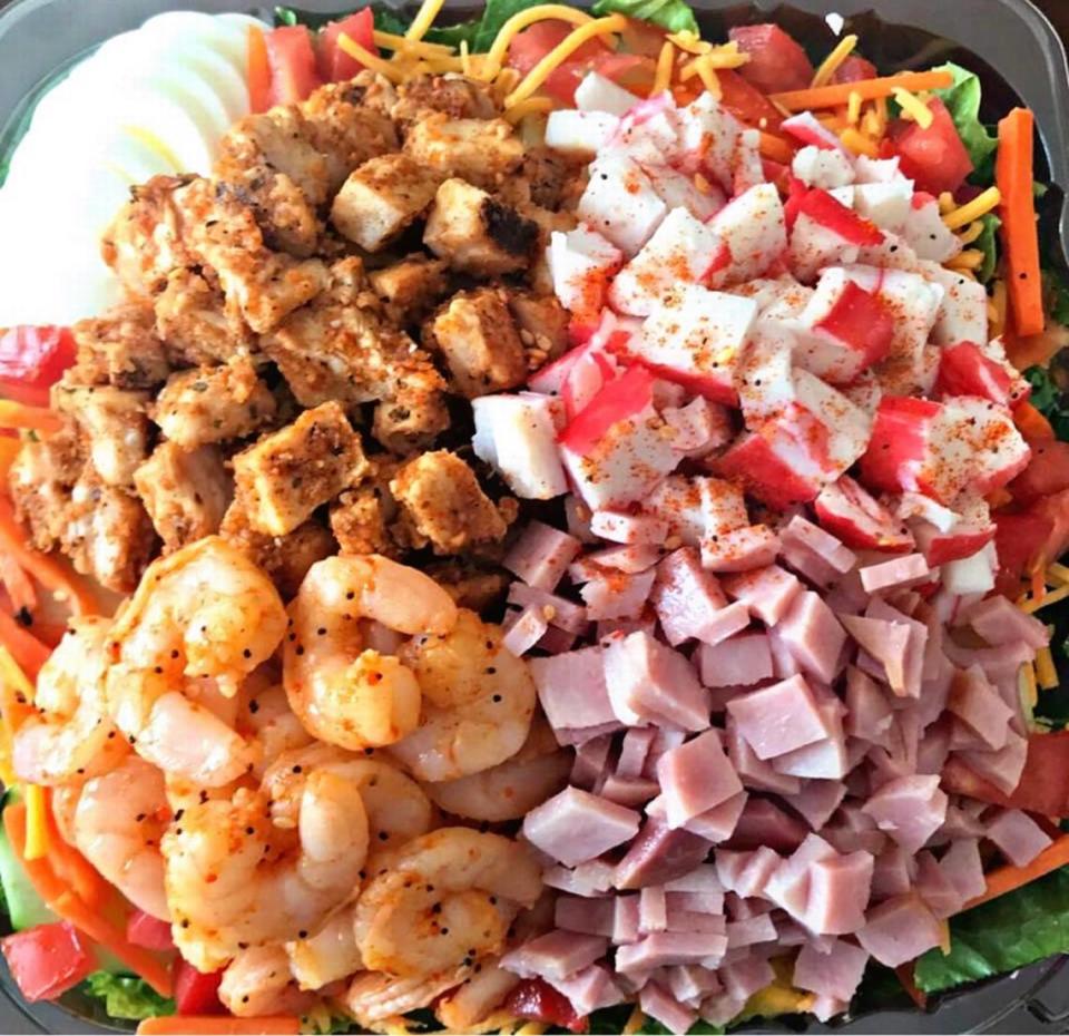 The Stack from The Salad Spot 2. This salad includes cheddar cheese, cucumbers, tomatoes, eggs, red and yellow peppers, black olives, crab, shrimp, ham and grilled chicken on a bed of iceberg lettuce. It comes only a large and costs $16.99