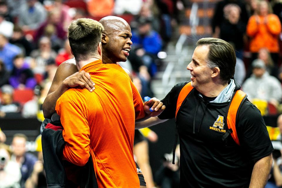 Ames coach Andy Fecht (right) is looking foward to a lot more celebrations with Danarii Mickel (left) and the other eight combined returning state wrestlers on the Little Cyclone boys and girls wrestling teams in 2023-2024.