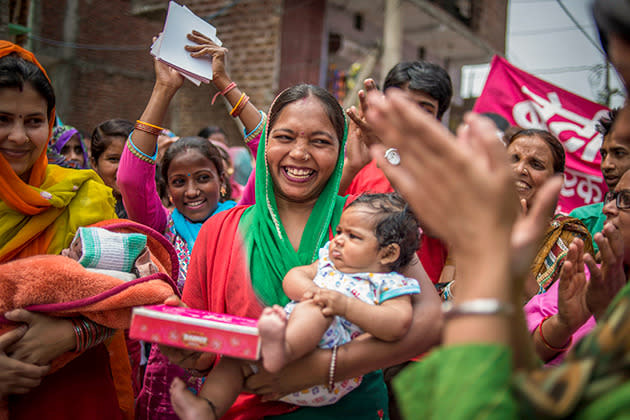 Proud mum Jyoty Chauhan, 26, receives a box of chocolates at a Beti Utsav party in New Delhi in celebration of the birth of her daughter.