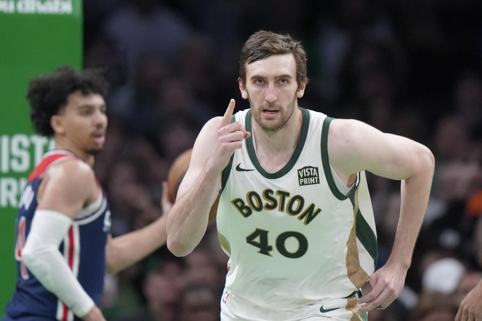 Boston Celtics center Luke Kornet, right, celebrates after scoring in front of Washington Wizards guard Jules Bernard, left, in the second half of an NBA basketball game, Sunday, April 14, 2024, in Boston. (AP Photo/Steven Senne)