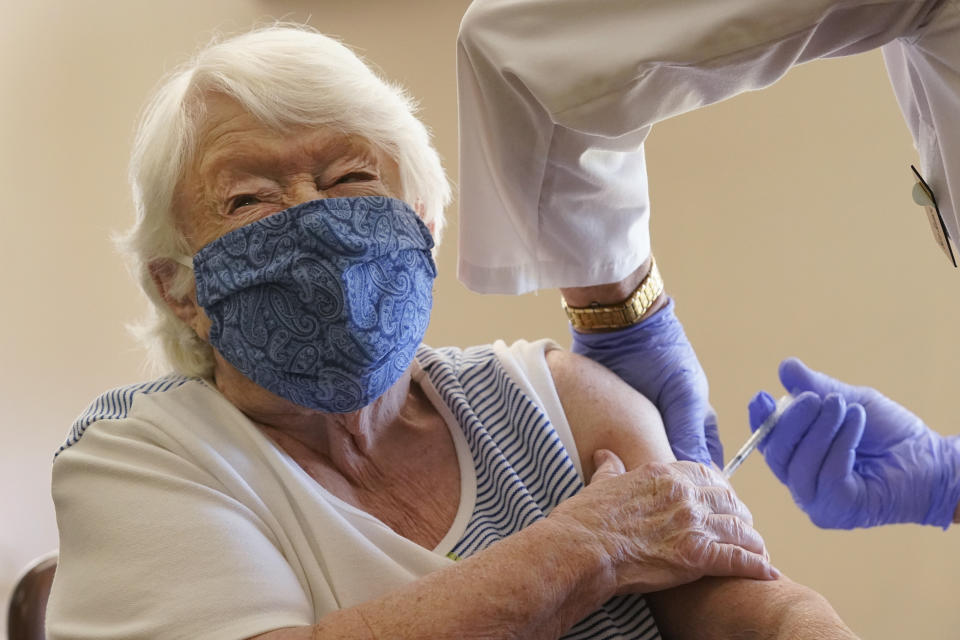 Nathalie Avery, 90, reacts as she gets the COVID-19 vaccine, Thursday, Jan. 21, 2021, at the Isles of Vero Beach assisted and independent senior living community in Vero Beach, Fla. As of Thursday, Jan. 28, 2021, 3.1 million doses have been given in long-term care facilities, according to the Centers for Disease Control and Prevention. That's about 30% of the roughly 10 million vaccines that David Grabowski, a health policy professor at Harvard Medical School, estimates will be needed to fully protect residents and employees. (AP Photo/Wilfredo Lee)