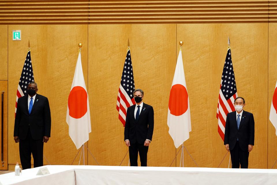 Japan's Prime Minister Yoshihide Suga (R) poses with U.S. Secretary of State Antony Blinken (C) and U.S. Defense Secretary Lloyd Austin (L) during a courtesy call at the prime minister's official residence in Tokyo on March 16, 2021.<span class="copyright">Eugene Hoshiko—POOL/AFP/Getty Images</span>