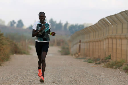 Lonah Chemtai, a Kenyan-born runner who will represent Israel in the women's marathon at the 2016 Rio Olympics, trains near their house in Moshav Yanuv, central Israel July 14, 2016. REUTERS/Baz Ratner