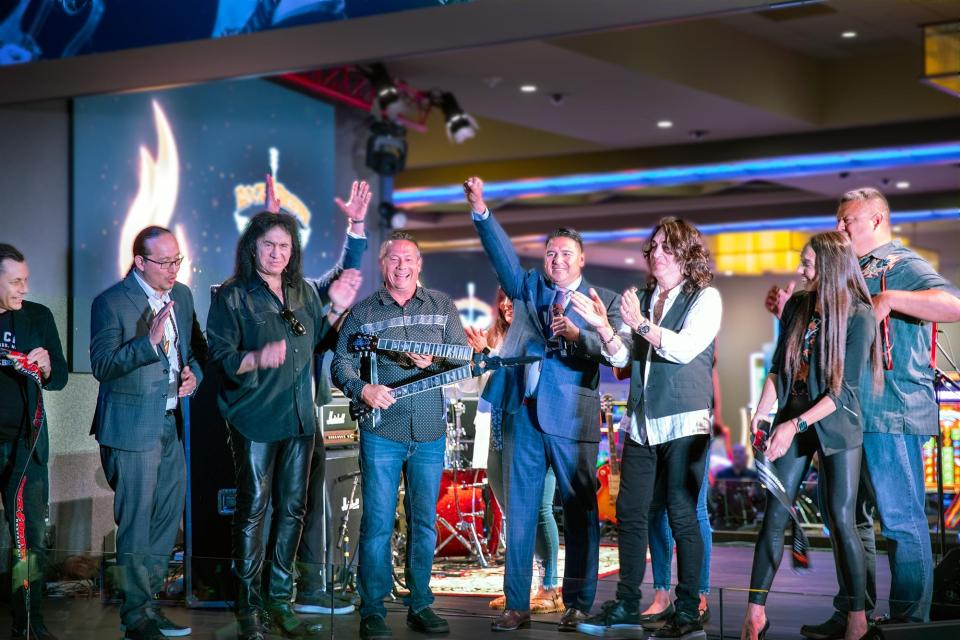 Ron Hall (Vice President of F&B Potawatomi Casino Hotel), Brooks Boyd (Forest County Potawatomi Council Member), Gene Simmons (KISS), James A. Crawford (Forest County Potawatomi Chairman), Dominic Ortiz (CEO Potawatomi Casino Hotel), Paul Stanley (KISS), Alexx Zawada (CMO Potawatomi Casino Hotel) and Manny Johnson II (Treasurer Forest County Potawatomi Community) take part in the ribbon-cutting ceremony for the new Rock & Brews at Potawatomi Casino Hotel on Tuesday.