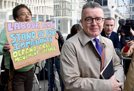 Britain's Deputy Leader of the Labour Party Tom Watson arrives at Labour's National Executive Committee meeting, as a protester holds a sign, in London, Britain April 30, 2019. REUTERS/Toby Melville