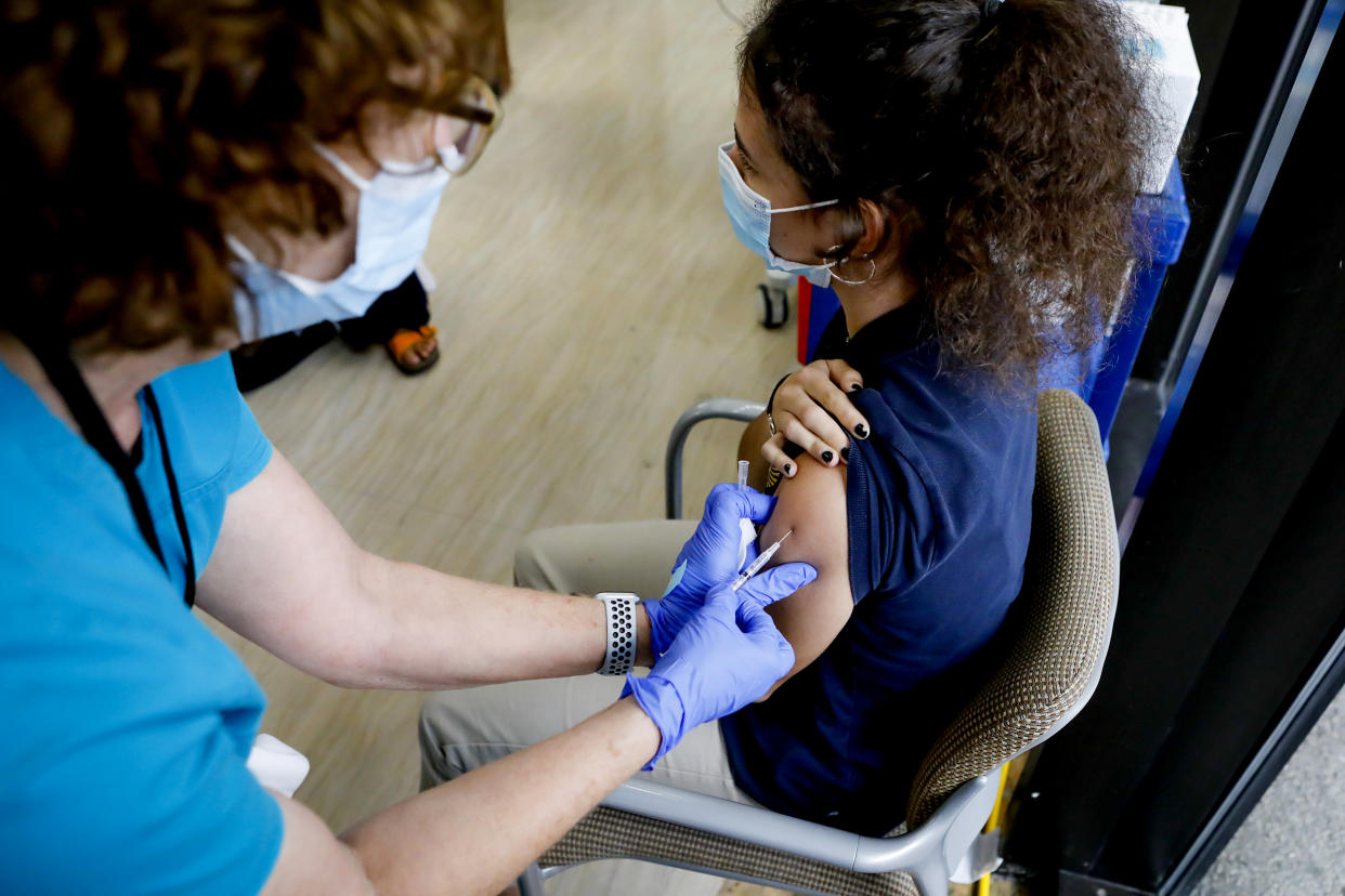 A healthcare worker administers a dose of the Pfizer-BioNTech Covid-19 vaccine to a teenager at Holtz Children's Hospital in Miami on May 18, 2021. (Eva Marie Uzcategui / Bloomberg via Getty Images file)