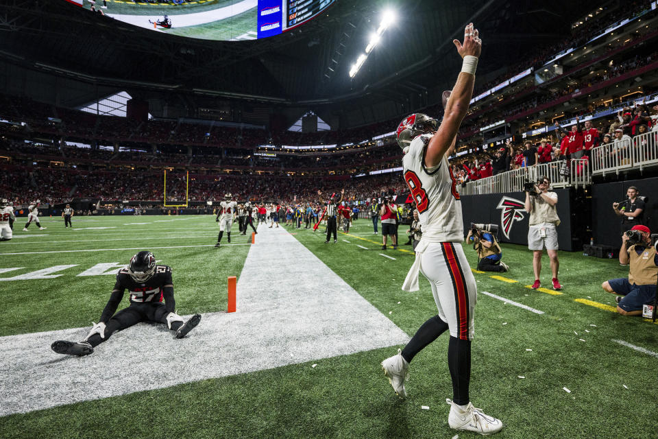Tampa Bay Buccaneers tight end Cade Otton (88) celebrates after his winning touchdown catch as Atlanta Falcons safety Richie Grant (27) reacts during the second half of an NFL football game, Sunday, Dec. 10, 2023, in Atlanta. (AP Photo/Danny Karnik)