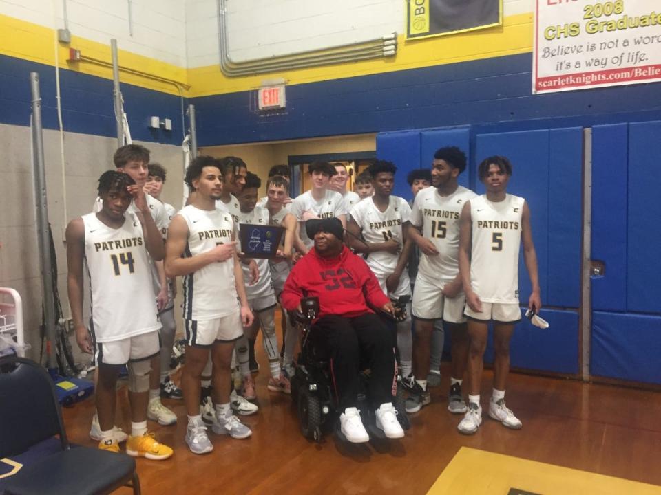 The Colonia boys basketball team poses with alum Eric LeGrand after beating Snyder to win the North 2 championship on Feb. 27, 2023