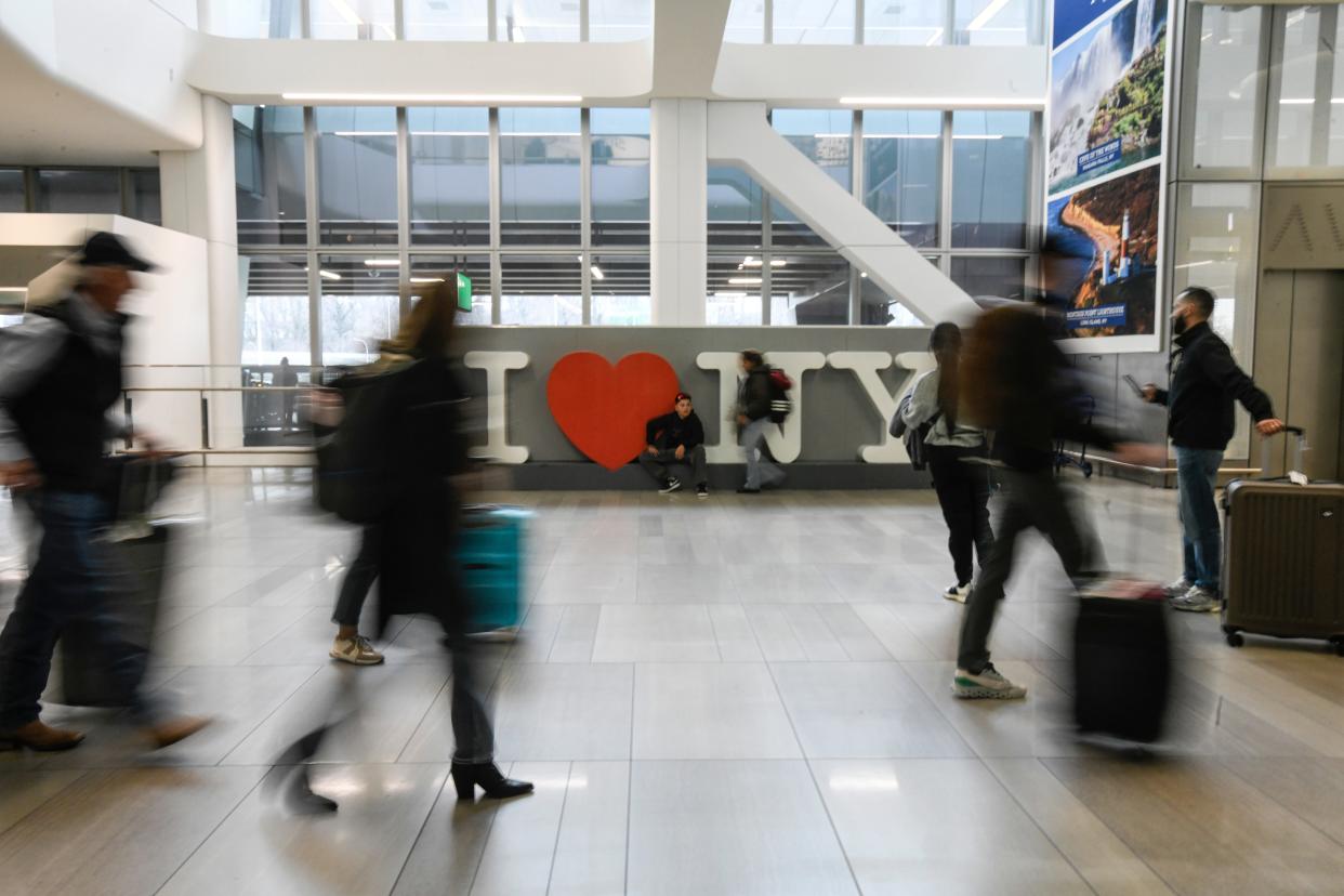 Passengers with their bags at LaGuardia Airport terminal B.