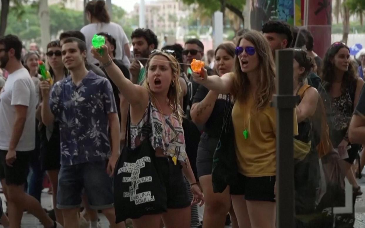 Anti-tourism protesters spray tourists with water pistols