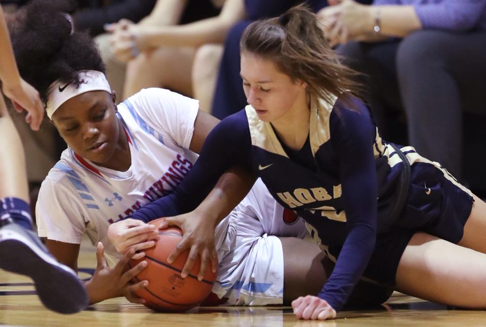 Villa Angela-St. Joseph's Shiya Clayton and Archbishop Hoban's Emma Rasmussen battle for a loose ball in the first half of the Knights' 77-21 win Monday night in Akron. [Mike Cardew/Beacon Journal]