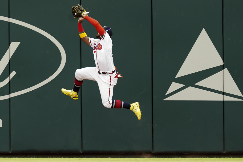 Atlanta Braves right fielder Ronald Acuna Jr. (13) makes a leaping catch on a fly ball from Philadelphia Phillies' Bryson Stott in the second inning of a baseball game Wednesday, Aug. 3, 2022, in Atlanta. (AP Photo/John Bazemore)
