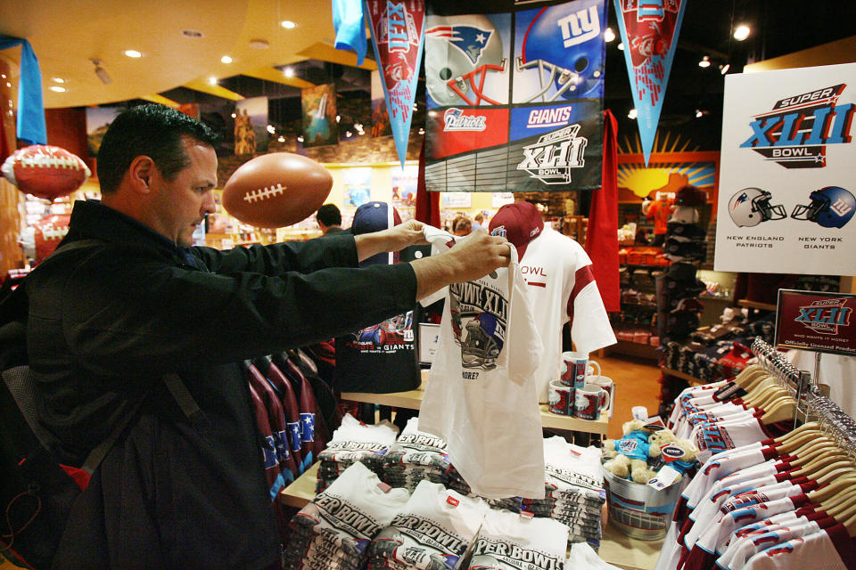 In this Jan. 29, 2008 file photo, Mike San Miguel, of La Verne, Calif., checks out the Super Bowl merchandise in the Arizona Highways retail store at Phoenix Sky Harbor International Airport before catching a flight. Broadway producers, merchants and restaurateurs may not see the profits they hope will come with the Super Bowl visiting New York as fans will more likely spend their money on NFL branded merchandise and events. (AP Photo/Ross D. Franklin, File)