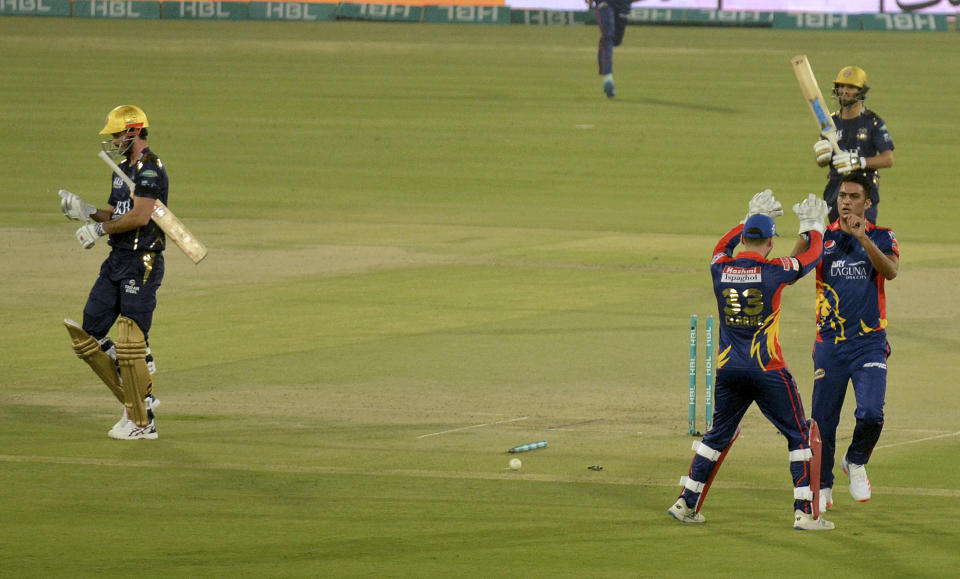 Karachi Kings Arshad Iqbal, right, celebrates with teammate Joe Clarke after taking the wicket of Quetta Gladiators Ben Cutting, left, during a Pakistan Super League T20 cricket match between Karachi Kings and Quetta Gladiators at National Stadium, in Karachi, Pakistan, Saturday, Feb. 20 2021. (AP Photo/Fareed Khan)