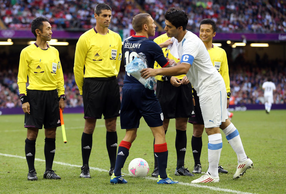 CARDIFF, WALES - AUGUST 01: Craig Bellamy of Great Britain meets Luis Suarez of Uruguay at the start of the Men's Football first round Group A match between Great Britain and Uruguay on Day 5 of the London 2012 Olympic Games at Millennium Stadium on August 1, 2012 in Cardiff, Wales. (Photo by Julian Finney/Getty Images)