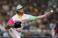 San Diego Padres relief pitcher Josh Hader overthrows first as Washington Nationals' Lane Thomas arrives safely for a single during the ninth inning of a baseball game Friday, Aug. 19, 2022, in San Diego. Washington Nationals' Victor Robles scored from first and Hader picked up a throwing error on the play. (AP Photo/Gregory Bull)