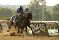 FILE - Essential Quality (2), Luis Saez up, crosses the finish line ahead of Hot Rod Charlie (4), Flavien Prat up, to win the 153rd running of the Belmont Stakes horse race, Saturday, June 5, 2021, at Belmont Park in Elmont, N.Y. Medina Spirit, controversial winner of the Kentucky Derby, and Belmont Stakes winner Essential Quality head a field of 10 horses for the Breeders’ Cup Classic, with trainer Brad Cox pre-entering two horses for the $6 million race that includes Hot Rod Charlie. (AP Photo/Eduardo Munoz Alvarez, File)