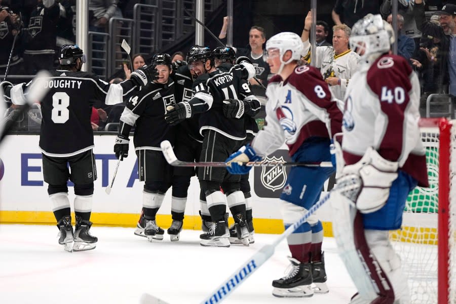 Members of the Los Angeles Kings celebrate a goal by center Quinton Byfield as Colorado Avalanche defenseman <span class="caas-xray-inline-tooltip"><span class="caas-xray-inline caas-xray-entity caas-xray-pill rapid-nonanchor-lt" data-entity-id="Cale_Makar" data-ylk="cid:Cale_Makar;pos:2;elmt:wiki;sec:pill-inline-entity;elm:pill-inline-text;itc:1;cat:Athlete;" tabindex="0" aria-haspopup="dialog"><a href="https://search.yahoo.com/search?p=Cale%20Makar" data-i13n="cid:Cale_Makar;pos:2;elmt:wiki;sec:pill-inline-entity;elm:pill-inline-text;itc:1;cat:Athlete;" tabindex="-1" data-ylk="slk:Cale Makar;cid:Cale_Makar;pos:2;elmt:wiki;sec:pill-inline-entity;elm:pill-inline-text;itc:1;cat:Athlete;" class="link ">Cale Makar</a></span></span>, third from right, and goaltender Alexandar Georgiev, right, watch along with actor Will Ferrell, second from right, during the second period of an NHL hockey game Wednesday, Oct. 11, 2023, in Los Angeles. (AP Photo/Mark J. Terrill)