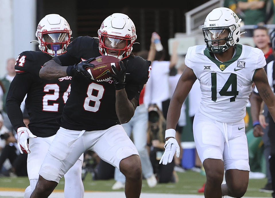 Houston linebacker Malik Robinson (8) intercepts a pass intended for Baylor Bears wide receiver Armani Winfield (14) during the second half of an NCAA college football game, Saturday, Nov. 4, 2023, in Waco, Texas. (Jerry Larson/Waco Tribune-Herald via AP)