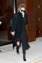 <p>Heading to New York's JFK airport, Gigi wore a black turtleneck with distressed <a href="http://www.7forallmankind.com/josefina-with-open-holes-in-black-/d/13158C26506?CategoryId=3310" rel="nofollow noopener" target="_blank" data-ylk="slk:7 For All Mankind;elm:context_link;itc:0;sec:content-canvas" class="link ">7 For All Mankind</a> jeans, a black Smythe coat and Sandro ankle boots. </p>