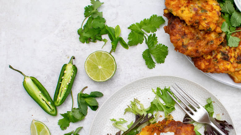 fritters with scattered lime, jalapeño, herbs