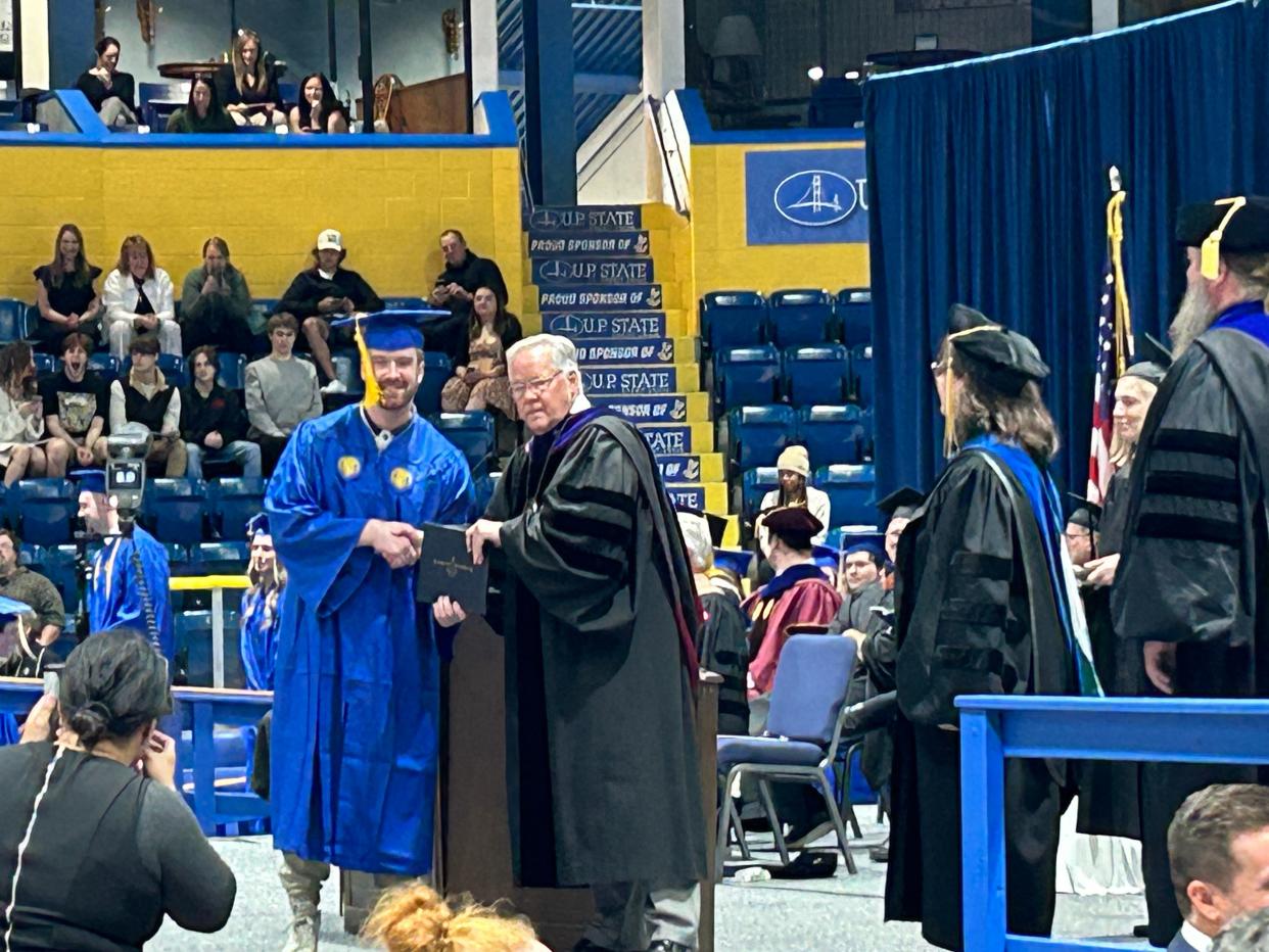 As they walk across the stage, Interim President Lynn Gillette hands students their diplomas on Saturday, May 4, 2024 during the Lake Superior State University commencement ceremony.