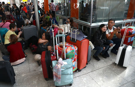 People wait with their luggage at Heathrow Terminal 5 in London, Britain May 27, 2017. REUTERS/Neil Hall