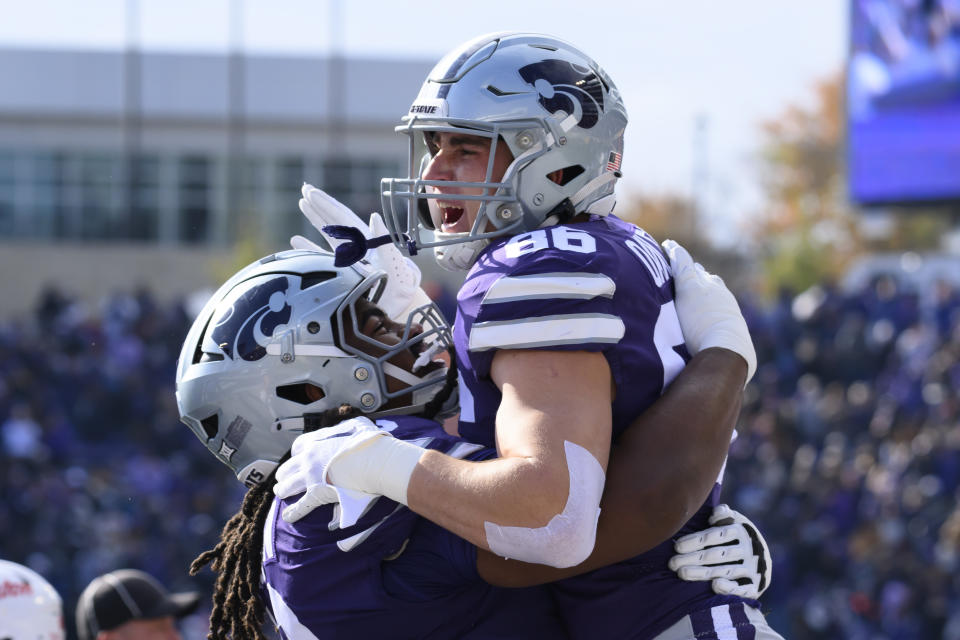Kansas State tight end Garrett Oakley (86) celebrates his touchdown against Houston with offensive lineman KT Leveston (70) during the first half of an NCAA college football game in Manhattan, Kan., Saturday, Oct. 28, 2023. (AP Photo/Reed Hoffmann)