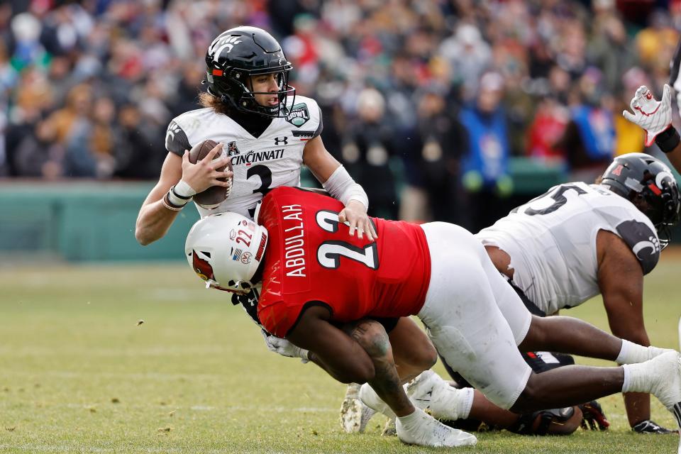 Cincinnati quarterback Evan Prater is sacked by Louisville's Yasir Abdullah during the second quarter of the Fenway Bowl NCAA college football game at Fenway Park Saturday, Dec. 17, 2022, in Boston. (AP Photo/Winslow Townson)