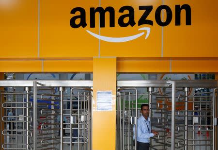 An employee of Amazon walks through a turnstile gate inside an Amazon Fulfillment Centre (BLR7) on the outskirts of Bengaluru, India, September 18, 2018. REUTERS/ Abhishek N. Chinnappa/Files