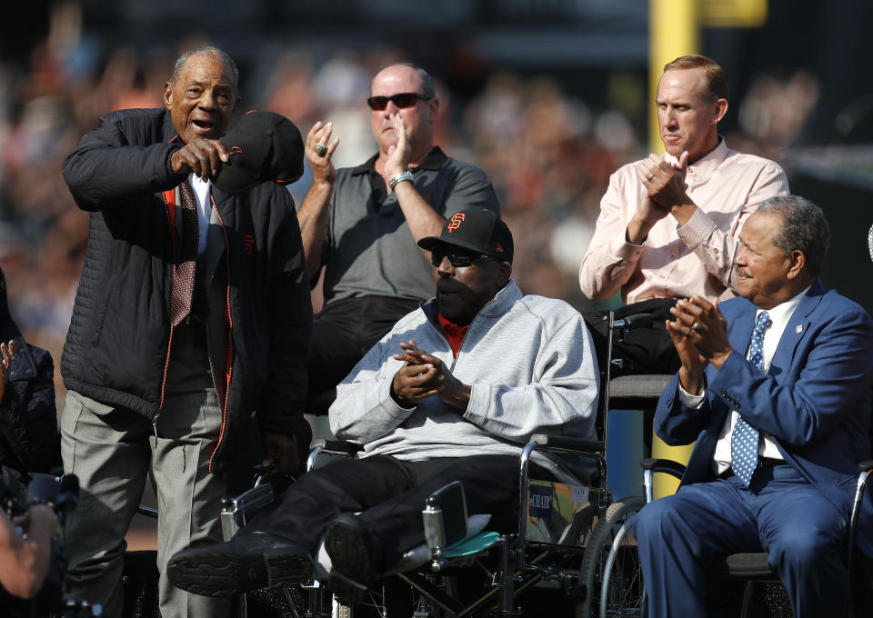 Former San Francisco Giants players Willie Mays, Will Clark, Kirk Rueter, Juan Marichal and Willie McCovey, clockwise from left, acknowledge fans during a ceremony to retire Barry Bonds' jersey number before a baseball game between the Giants and the Pittsburgh Pirates in San Francisco, Saturday, Aug. 11, 2018. (John G. Mabanglo/Pool Photo via AP)