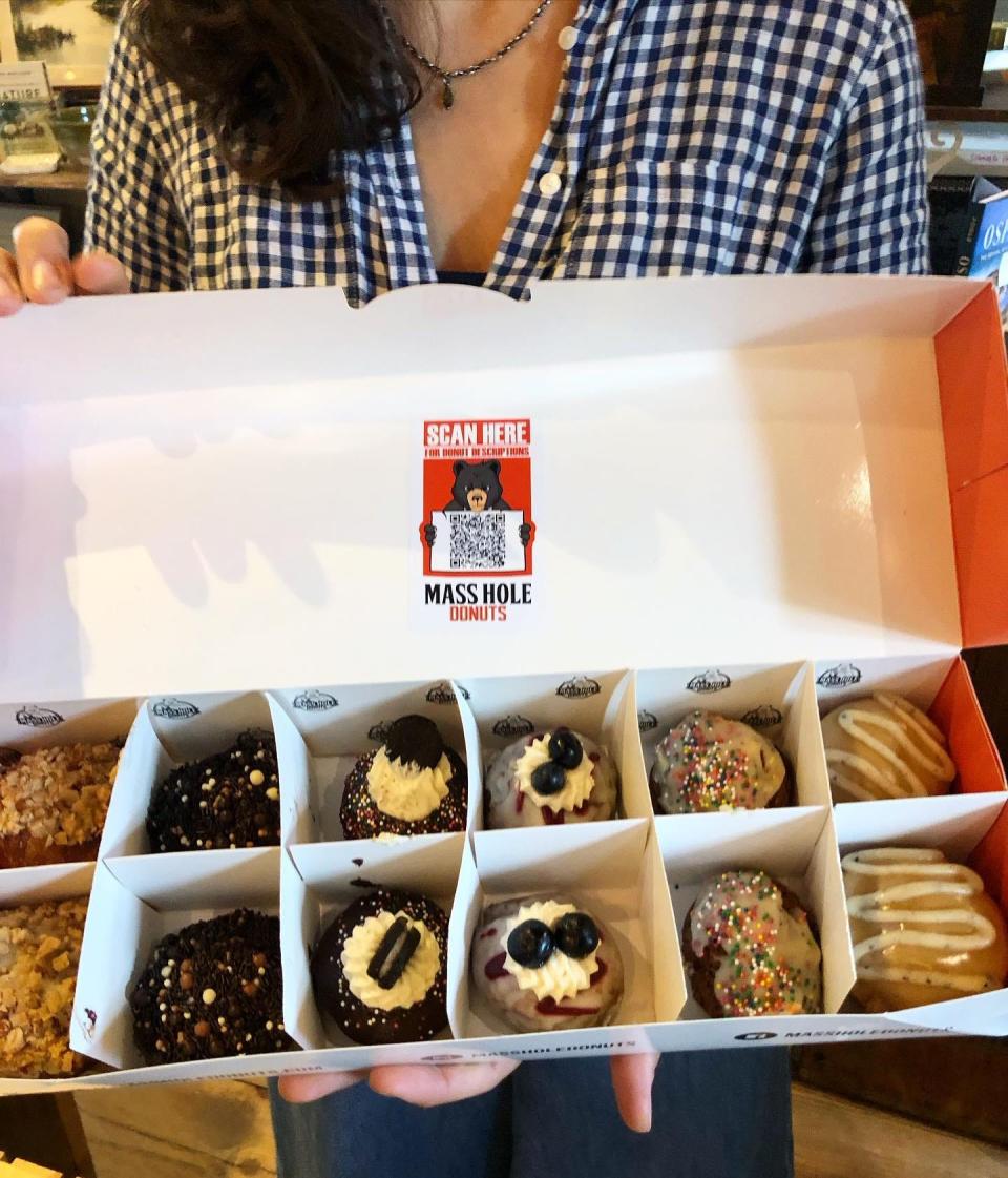 Davoll’s manager Mary Ann Buckley showing off freshly baked donuts.