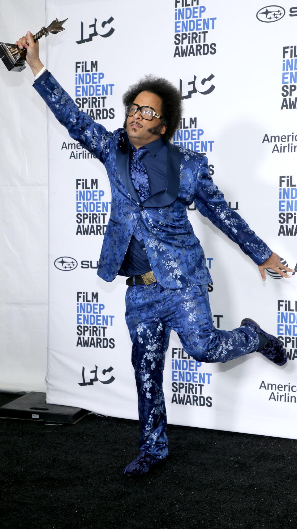 Boots Riley posing in blue sequin suit.