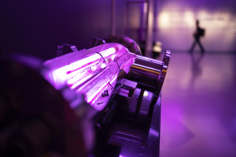 A display shows the ultraviolet light technology used to treat wastewater as a group tours the NEWater visitor center in Singapore, Tuesday, July 18, 2023. At the NEWater processing facility, visitors can walk through mock tunnels, see the inside of filters and answer quizzes on ways they can better reduce their own water use while being able to watch water quality checks in real-time. (AP Photo/David Goldman)