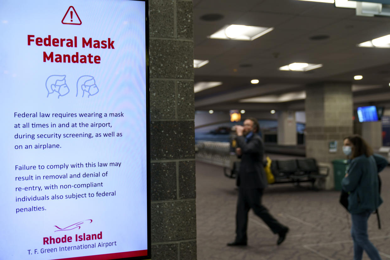 Instructions on a federal mask mandate is still displayed on a screen as Rhode Island T.F. Green International Airport worked on updating their signage Tuesday, April 19, 2022, in Providence, R.I. after a court order lifted the mandate Monday. A federal judge's decision to strike down a national mask mandate was met with cheers on some airplanes but also concern about whether it's really time to end one of the most visible vestiges of the COVID-19 pandemic. (AP Photo/David Goldman)