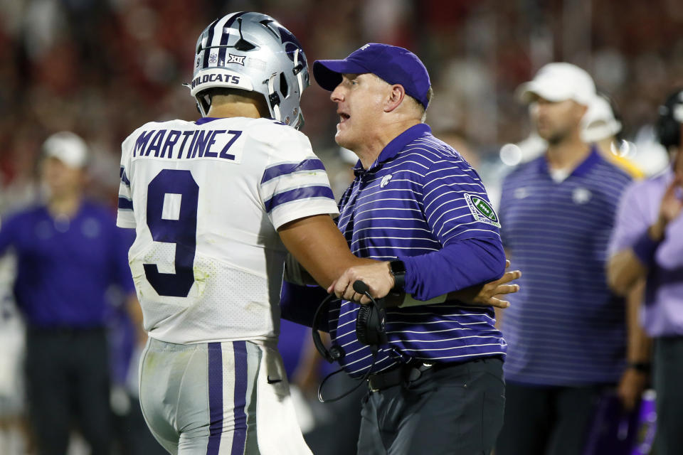 Kansas State coach Chris Klieman talks to quarterback Adrian Martinez during the second half of the team's NCAA college football game against Oklahoma, Saturday, Sept. 24, 2022, in Norman, Okla. (AP Photo/Nate Billings)